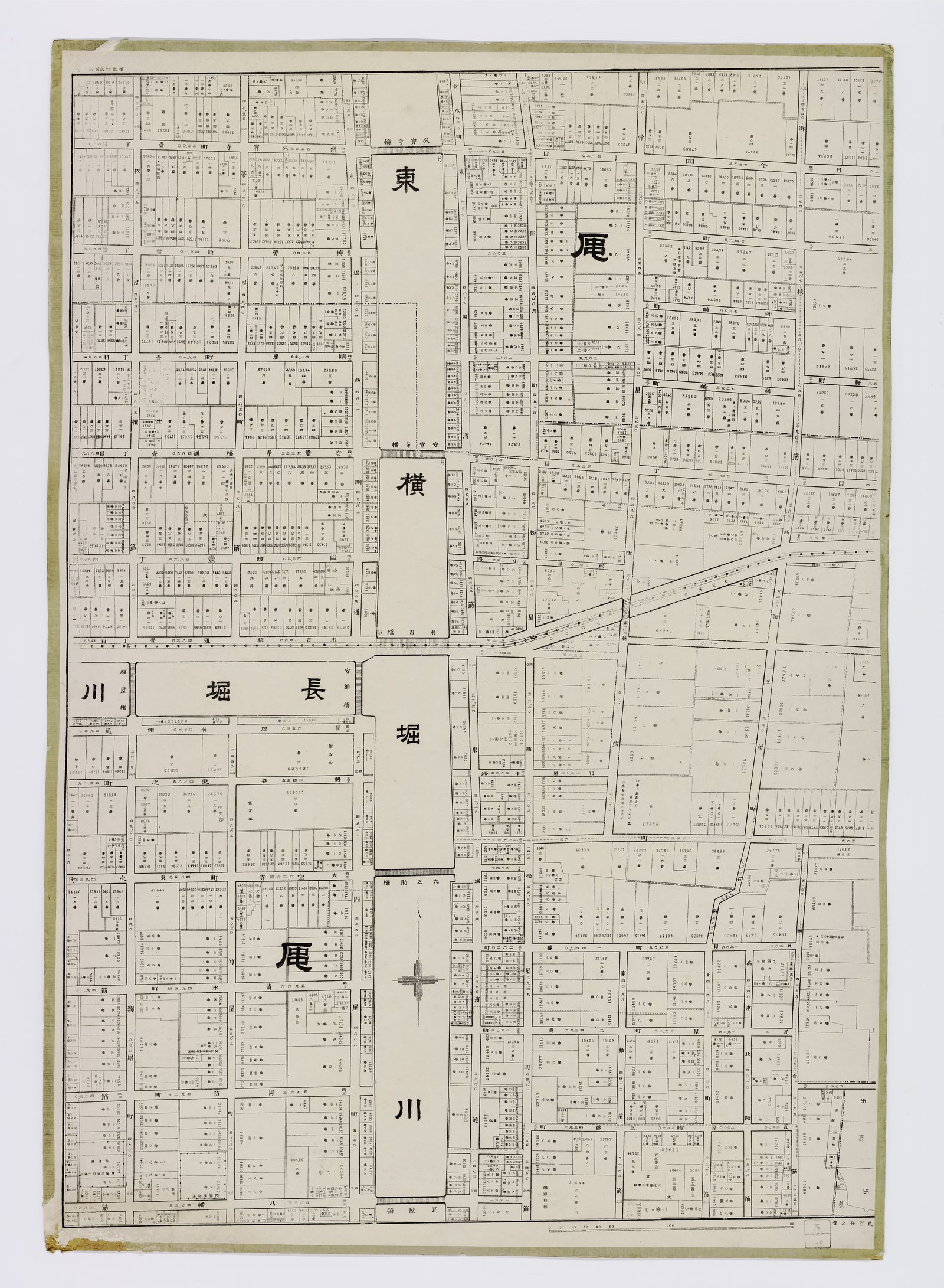One sheet of a hundred and eleven. Every parcel is drawn to its surveyed shape and numbered, with its measured area printed inside it; the full atlas carries <b>1,002 town names</b>, most of them still on the street signs today.<br><br>The state had surveyed Osaka three times by then, but at the scale a state cares about, and nobody had described the city lot by lot. Two private publishers did it independently, eleven months apart, in 1911 and 1912, for a city of over a million people in which the difference between one frontage and the next was worth a great deal of money.